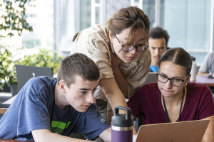 Students receive guidance from an instructor.