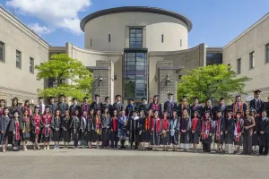 Newly inducted Phi Beta Kappa members from the Class of 2026 posing together outdoors near a campus building.