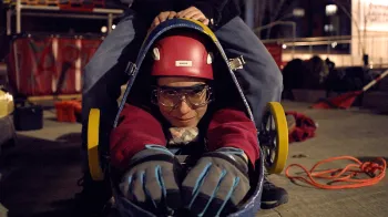 Front-facing photo of a woman in a buggy with protective equipment.
