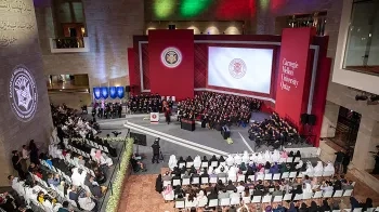 High up angle of a room with graduates on a stage