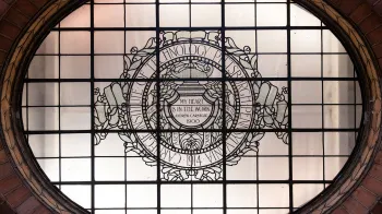 A window in Baker Hall that says "Carnegie Institute of Technology. Pittsburgh, Pennsylvania. 1914. My Heart is in the Work. Andrew Carnegie. 1900."